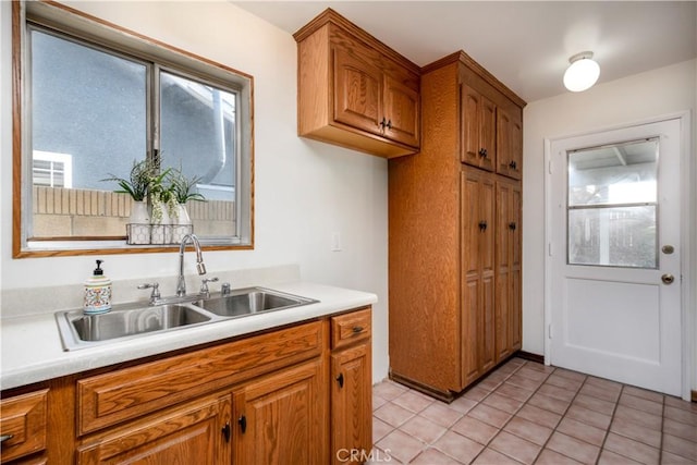 kitchen with light tile patterned flooring and sink