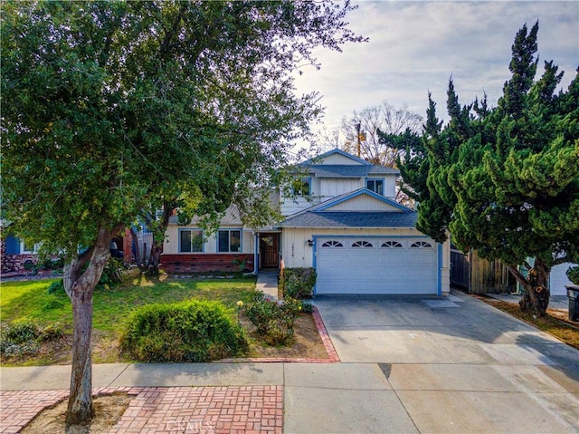 view of front of house featuring a garage and a front lawn