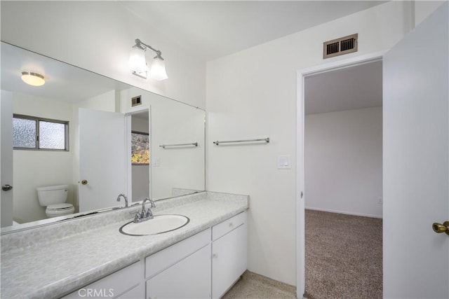 bathroom featuring vanity and toilet