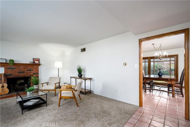 living room featuring a notable chandelier, light tile patterned floors, and a fireplace