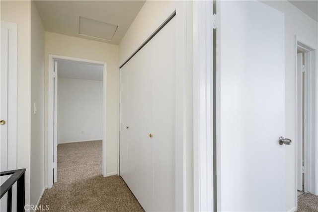 hallway with light colored carpet