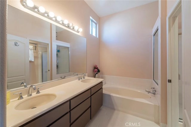 full bath with a garden tub, double vanity, a stall shower, and a sink