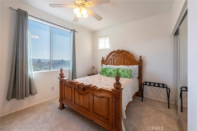 bedroom featuring light carpet, ceiling fan, and baseboards