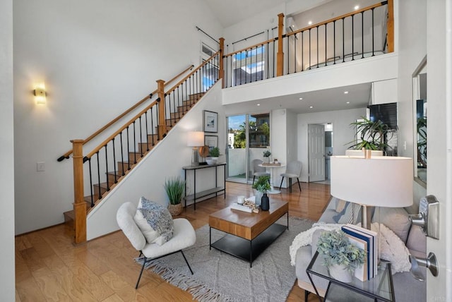 living room featuring a high ceiling and light wood-type flooring