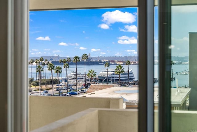 balcony featuring a water and mountain view