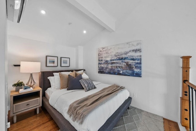 bedroom featuring hardwood / wood-style floors and vaulted ceiling with beams