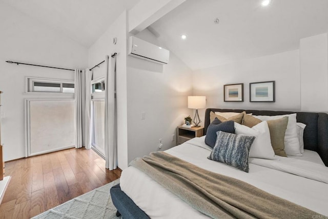 bedroom featuring lofted ceiling, access to exterior, hardwood / wood-style flooring, and a wall unit AC