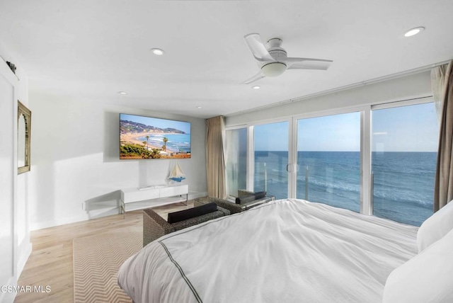 bedroom with light hardwood / wood-style flooring, access to outside, and ceiling fan