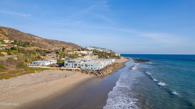 view of water feature with a mountain view and a view of the beach