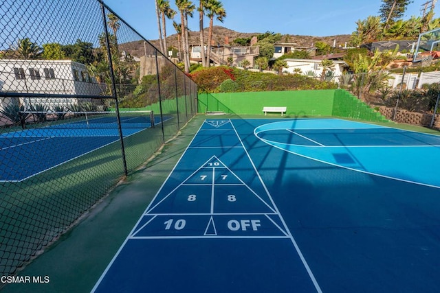 surrounding community featuring a mountain view and tennis court