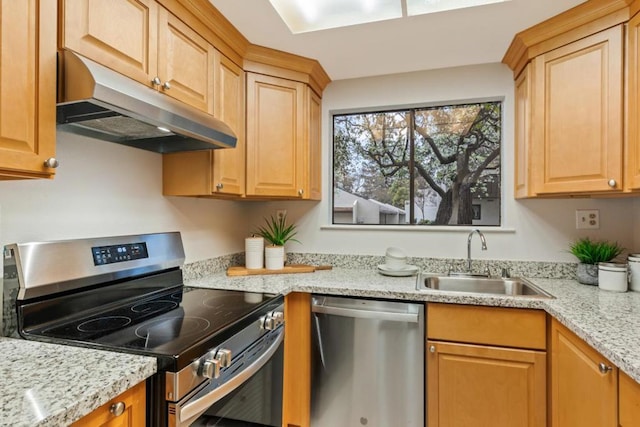 kitchen featuring appliances with stainless steel finishes, light stone countertops, and sink