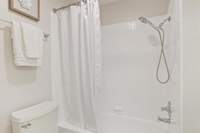 bathroom featuring toilet and shower / bath combo with shower curtain