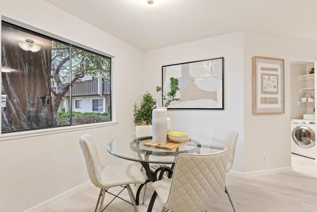 dining room with washer / clothes dryer and light hardwood / wood-style floors