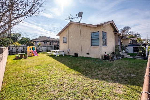 view of property exterior featuring a playground and a lawn