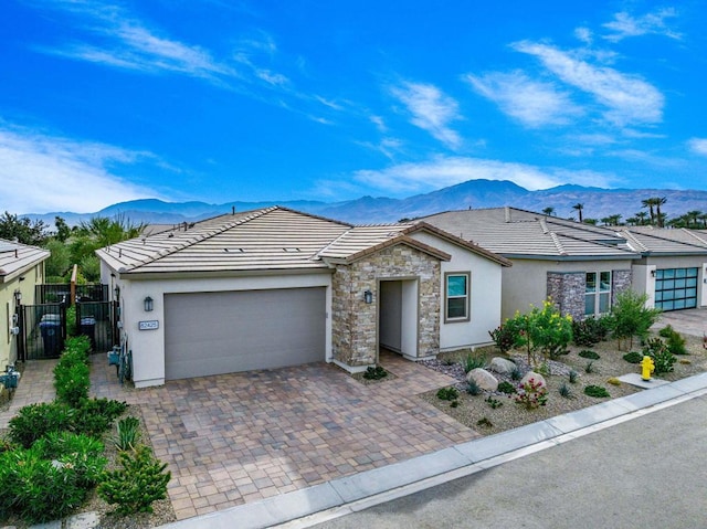 ranch-style home with a garage and a mountain view