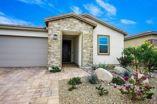 view of exterior entry featuring a garage