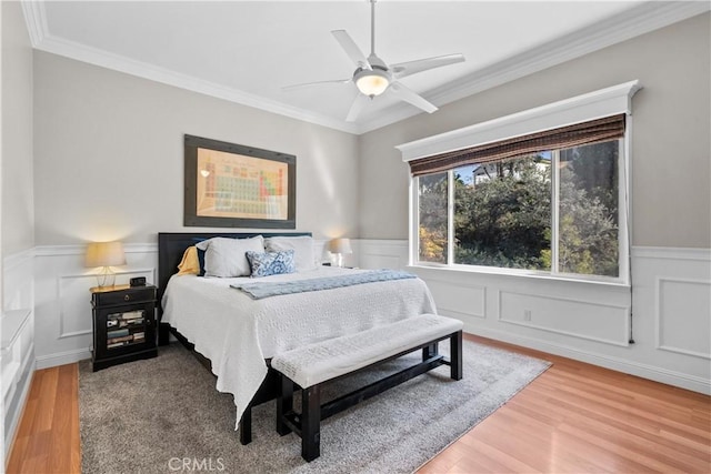 bedroom featuring crown molding, hardwood / wood-style floors, and ceiling fan