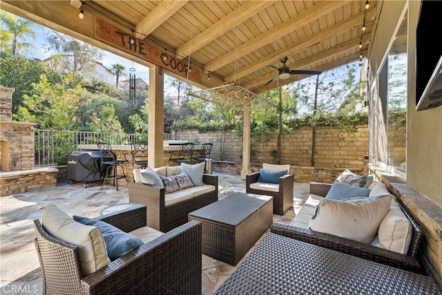 view of patio featuring ceiling fan, an outdoor living space, and grilling area