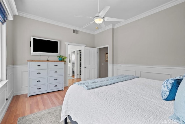 bedroom with crown molding, ceiling fan, and light wood-type flooring