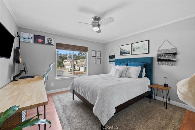 bedroom with crown molding, ceiling fan, and wood-type flooring