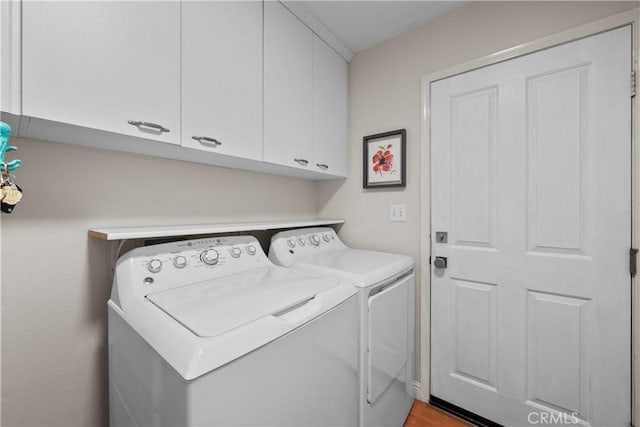 laundry area featuring cabinets and washing machine and dryer