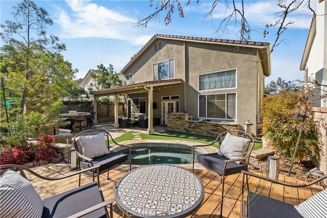 back of property featuring a patio, a wooden deck, an outdoor hangout area, a hot tub, and french doors