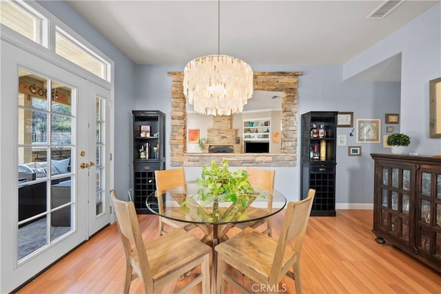 dining room with a chandelier and light hardwood / wood-style floors