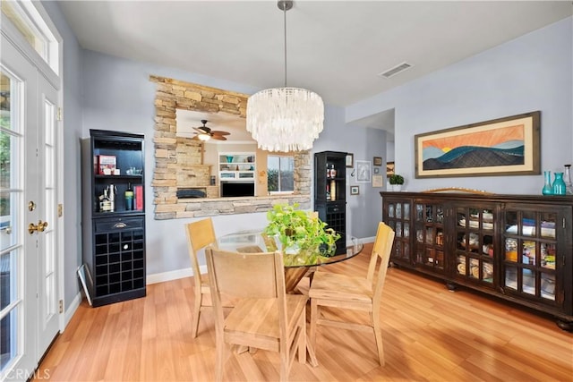 dining space featuring a notable chandelier and light hardwood / wood-style flooring