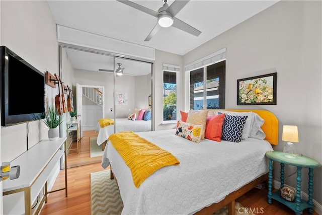 bedroom featuring hardwood / wood-style flooring, ceiling fan, and a closet