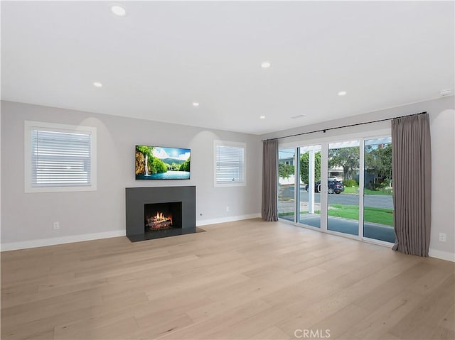 unfurnished living room with light hardwood / wood-style floors