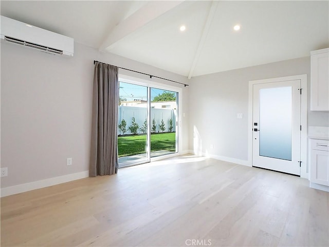 interior space with lofted ceiling with beams, light wood-type flooring, and a wall unit AC