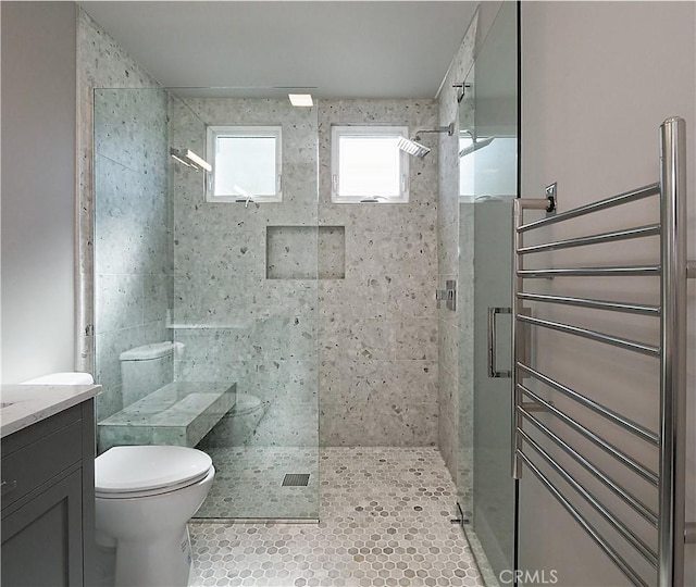 bathroom with toilet and a shower with shower door