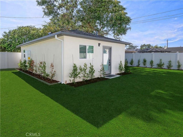 view of outbuilding with a yard