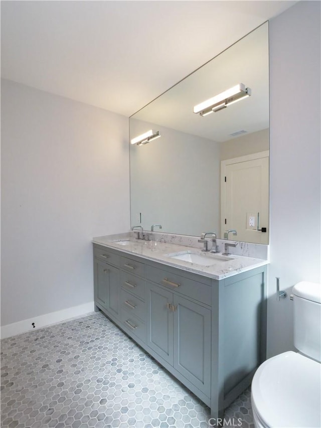 bathroom featuring vanity and toilet