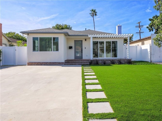 view of front of house with a patio and a front lawn