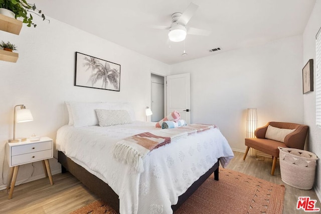 bedroom with ceiling fan and light wood-type flooring