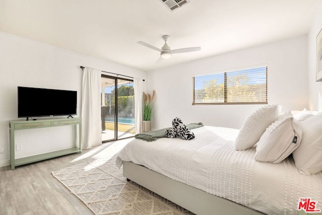 bedroom with access to exterior, light hardwood / wood-style flooring, and ceiling fan