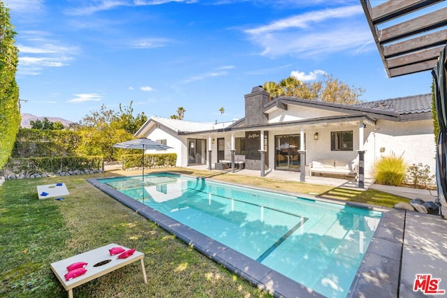 view of pool with a yard and a patio