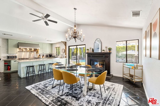 tiled dining area featuring vaulted ceiling with beams and ceiling fan with notable chandelier