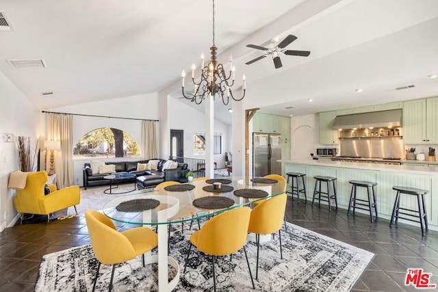 tiled dining area with lofted ceiling and ceiling fan with notable chandelier