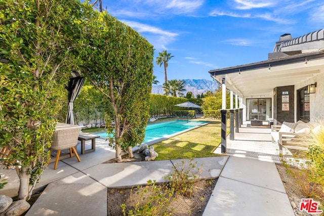 exterior space featuring a patio and a mountain view