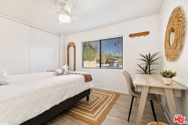 bedroom featuring hardwood / wood-style flooring, a closet, and ceiling fan