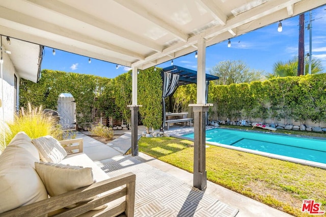 view of patio / terrace featuring a pergola and a fenced in pool