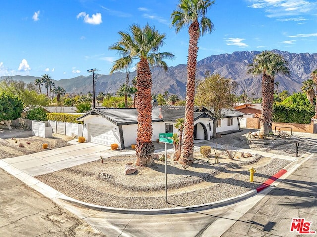 view of front of property featuring a mountain view and a garage