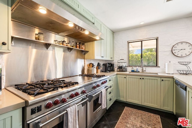 kitchen featuring sink, tasteful backsplash, appliances with stainless steel finishes, green cabinets, and custom range hood