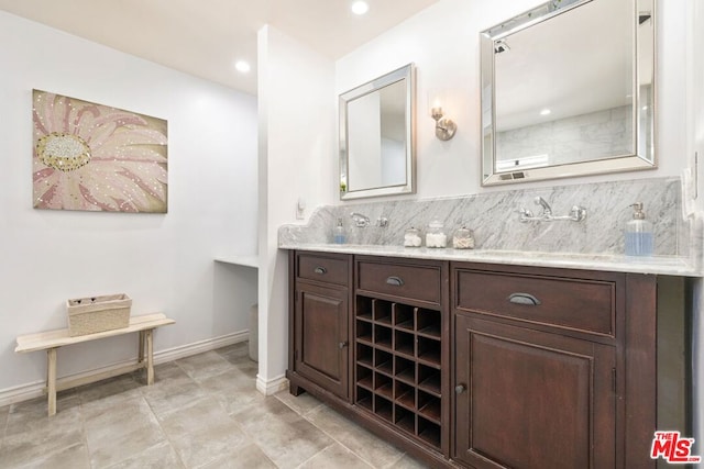 bathroom with vanity and decorative backsplash