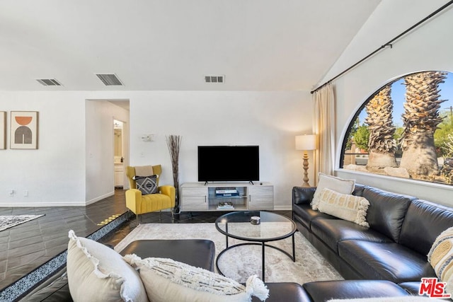 living room featuring vaulted ceiling and hardwood / wood-style floors