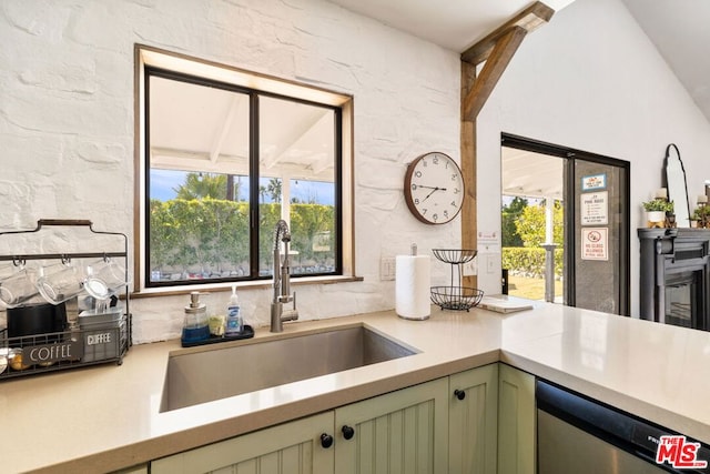 kitchen featuring dishwasher, sink, and green cabinets