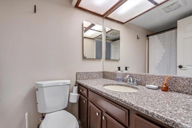 bathroom with vanity and toilet