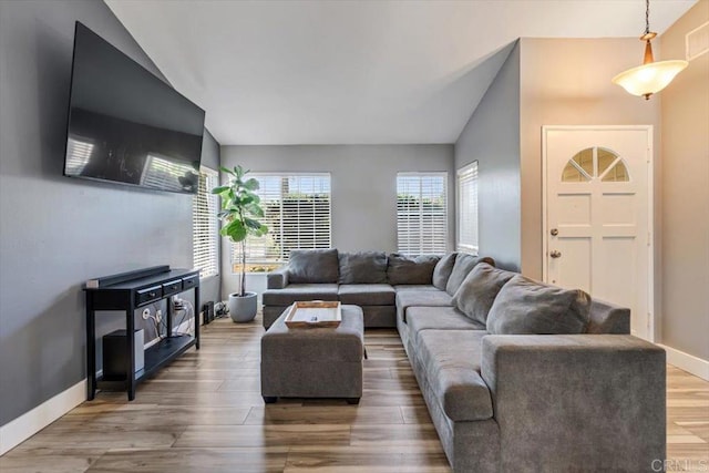 living room featuring vaulted ceiling and wood-type flooring